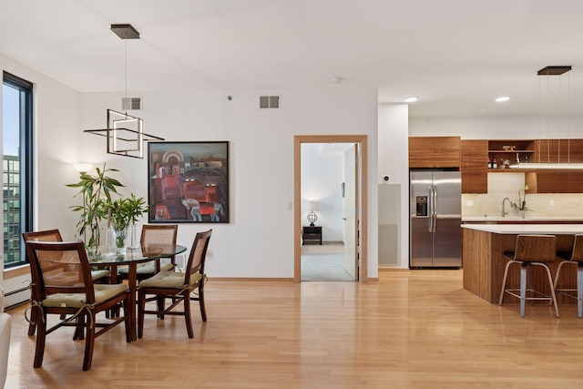 dining area featuring visible vents, recessed lighting, light wood-type flooring, and baseboards