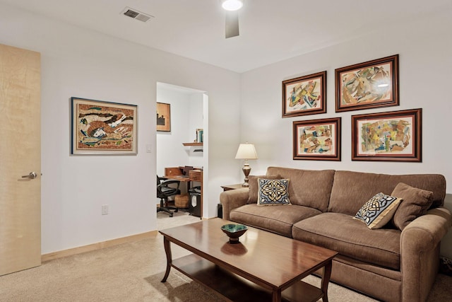 living area with light carpet, baseboards, visible vents, and ceiling fan