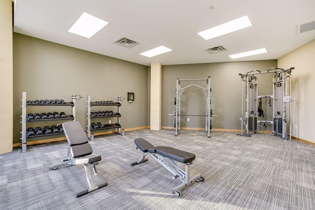 exercise room featuring carpet flooring, baseboards, and visible vents