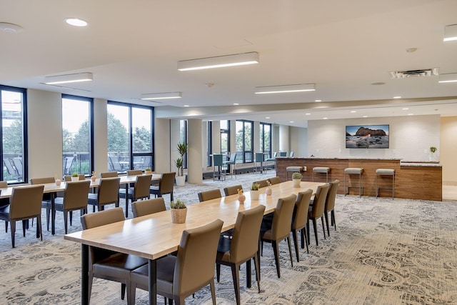 dining room with visible vents, recessed lighting, and expansive windows