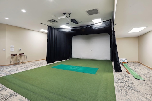 rec room featuring golf simulator, carpet, visible vents, and baseboards