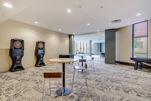 carpeted dining room featuring recessed lighting, visible vents, baseboards, and floor to ceiling windows