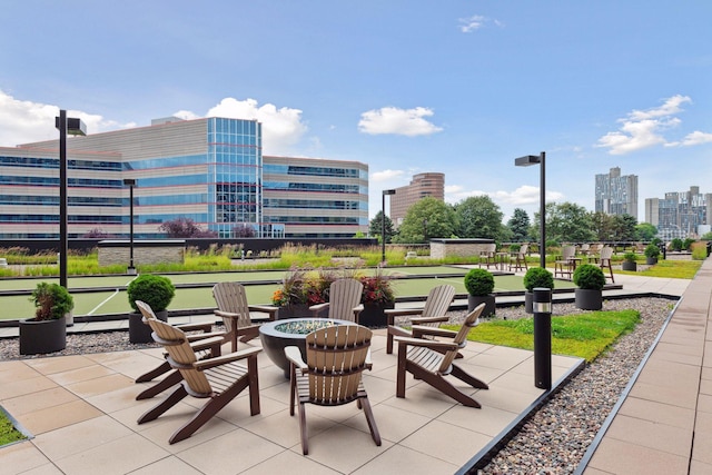 view of patio with a city view and an outdoor fire pit