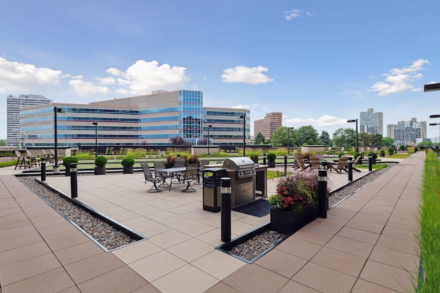 view of patio with a view of city and grilling area