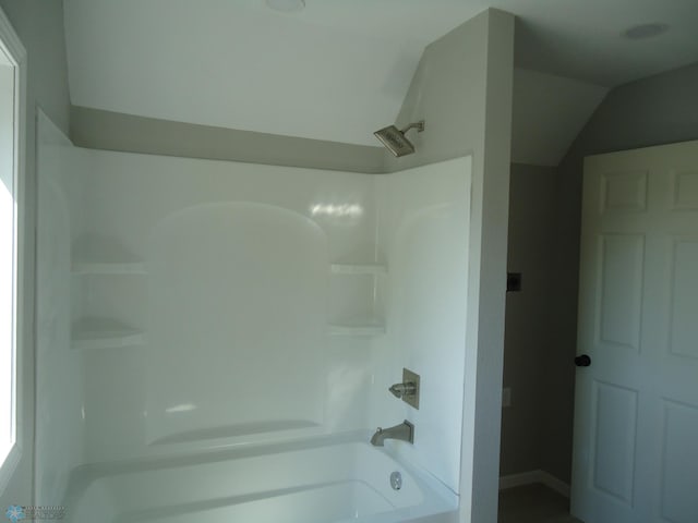 212 May Ave, Page, ND 58064 - bathroom featuring shower / tub combination, vaulted ceiling, and baseboards