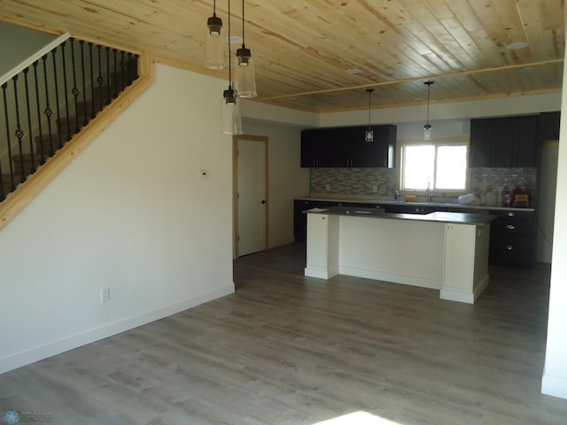212 May Ave, Page, ND 58064 - kitchen featuring wooden ceiling, dark cabinets, a kitchen island, wood finished floors, and backsplash