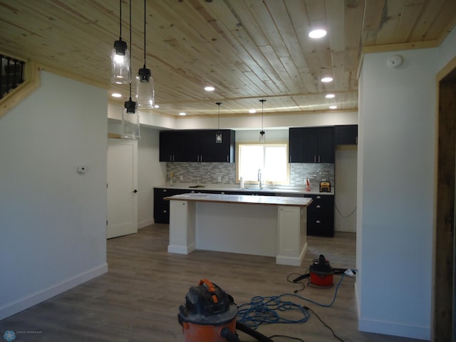 212 May Ave, Page, ND 58064 - kitchen with a kitchen island, wood ceiling, backsplash, light countertops, and dark cabinets