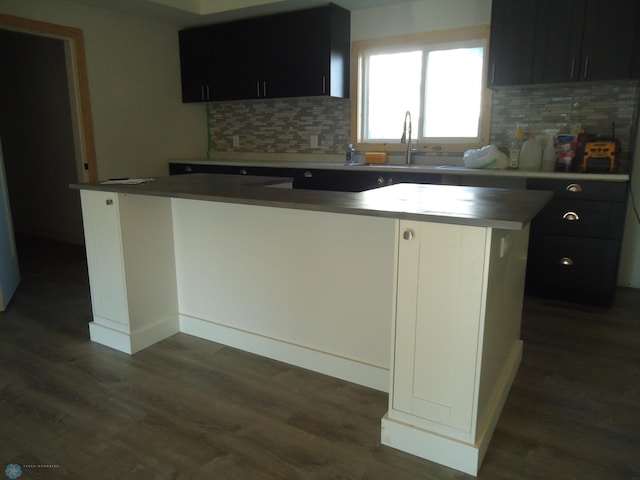 212 May Ave, Page, ND 58064 - kitchen with a sink, dark wood-style floors, decorative backsplash, and dark cabinets