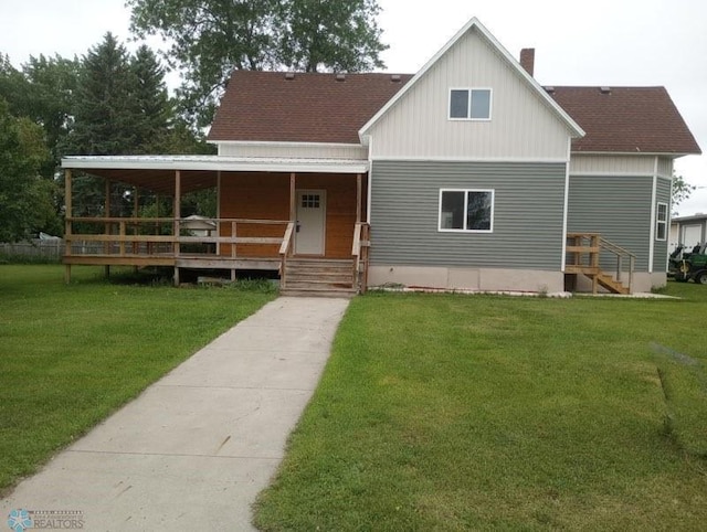 212 May Ave, Page, ND 58064 - view of front of property with covered porch, a front yard, a shingled roof, and a chimney