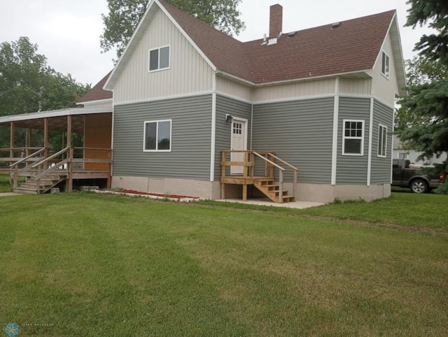 212 May Ave, Page, ND 58064 - rear view of house featuring a shingled roof, a chimney, and a lawn