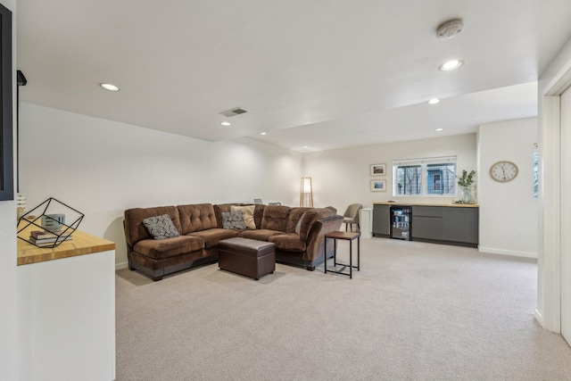 living room featuring wine cooler, a dry bar, recessed lighting, visible vents, and light carpet