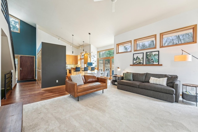 living room featuring high vaulted ceiling and wood finished floors