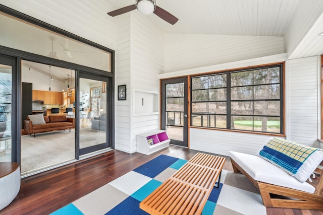 sunroom with vaulted ceiling and a ceiling fan