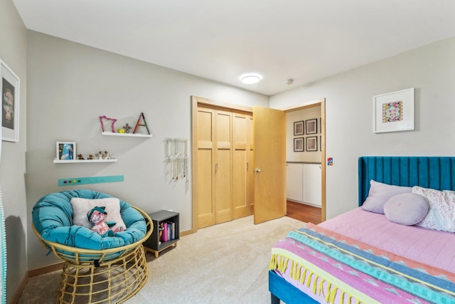 bedroom featuring carpet, baseboards, and a closet