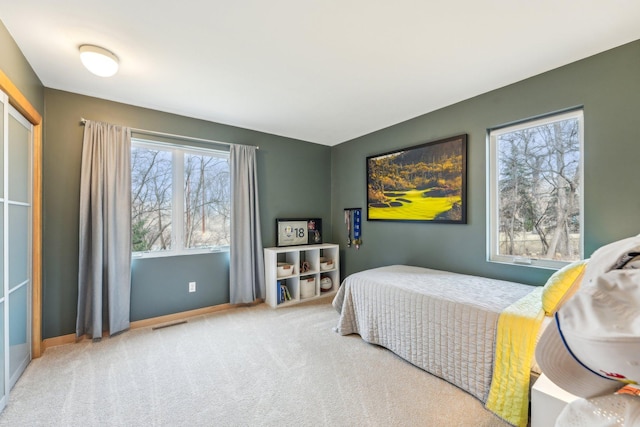 bedroom featuring carpet flooring, visible vents, and baseboards