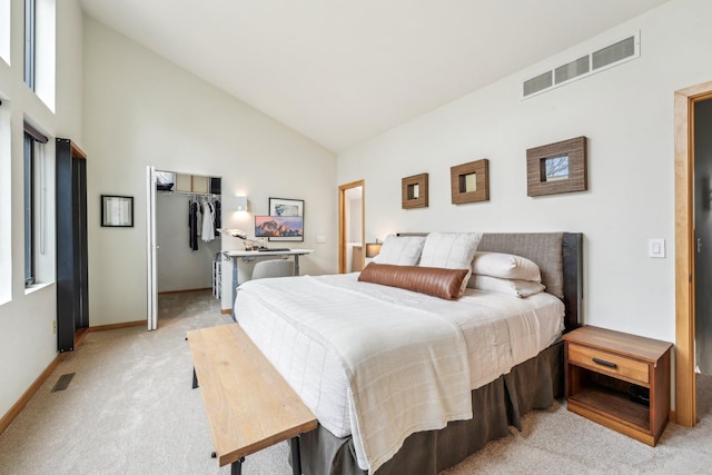 bedroom featuring high vaulted ceiling, light colored carpet, visible vents, and a spacious closet