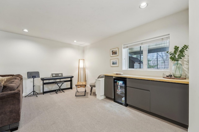 living area with light carpet, wine cooler, a dry bar, and recessed lighting