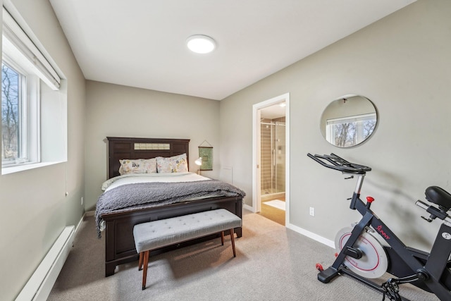 carpeted bedroom featuring a baseboard radiator, ensuite bath, and baseboards