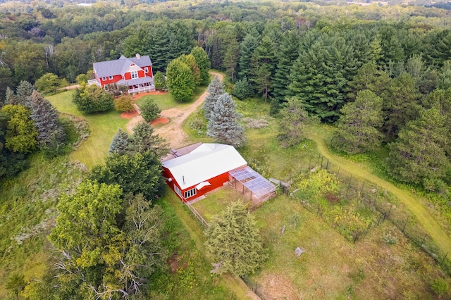 birds eye view of property with a view of trees