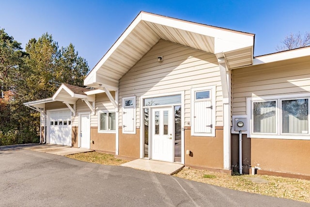 view of front of home with an attached garage and stucco siding