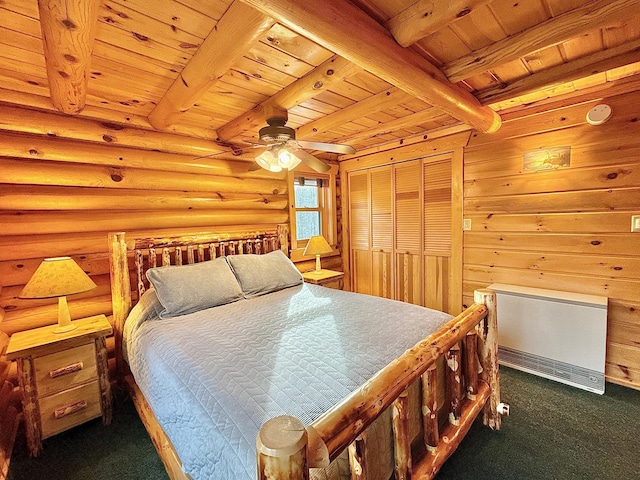 bedroom with wooden ceiling, carpet, beam ceiling, rustic walls, and a closet