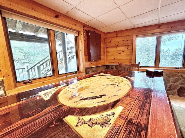 dining room with wood walls