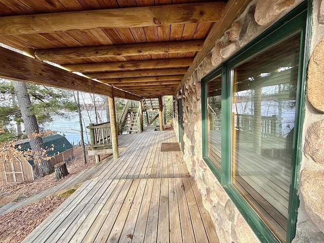 wooden deck with stairway and a water view