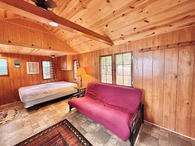 bedroom with stone tile flooring, wood walls, and french doors