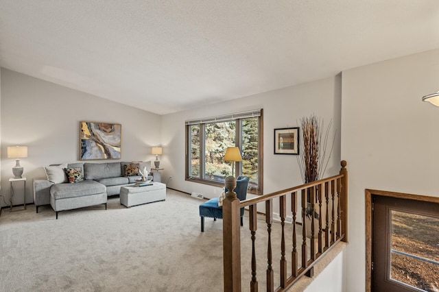 living room featuring vaulted ceiling, baseboards, visible vents, and light colored carpet