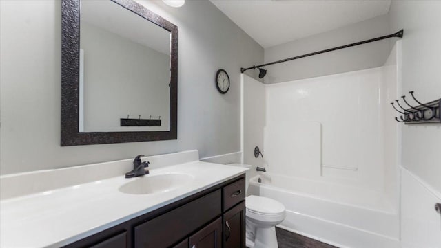 bathroom with shower / bath combination, vanity, and toilet