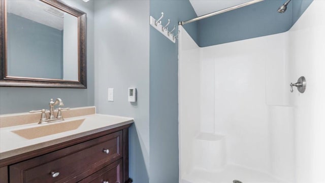 full bathroom with walk in shower and vanity