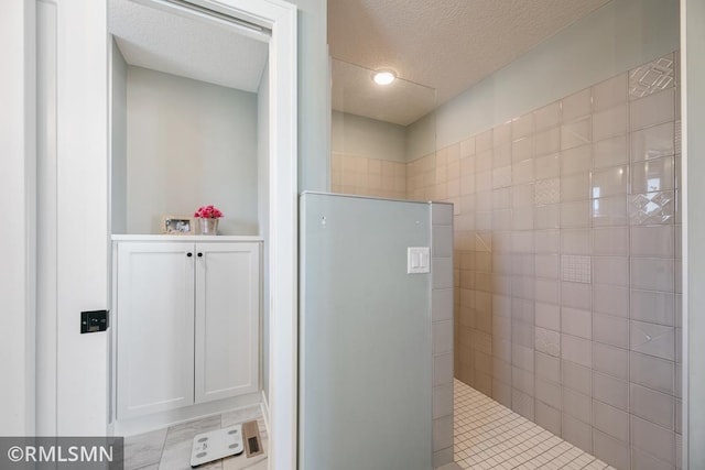 bathroom with a textured ceiling and a walk in shower