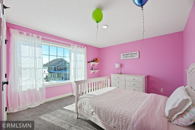 carpeted bedroom with baseboards and a textured ceiling