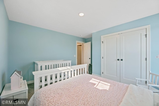 bedroom featuring a closet and baseboards