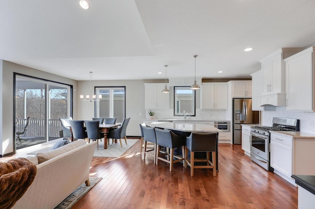 kitchen featuring hanging light fixtures, white cabinetry, and appliances with stainless steel finishes