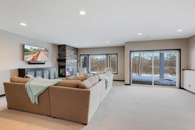 living area with a fireplace, recessed lighting, light carpet, a textured ceiling, and baseboards