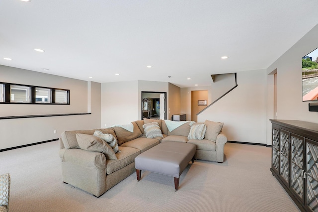 living room featuring recessed lighting, baseboards, and light colored carpet