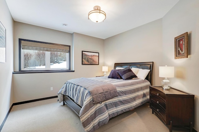 bedroom with light carpet and baseboards