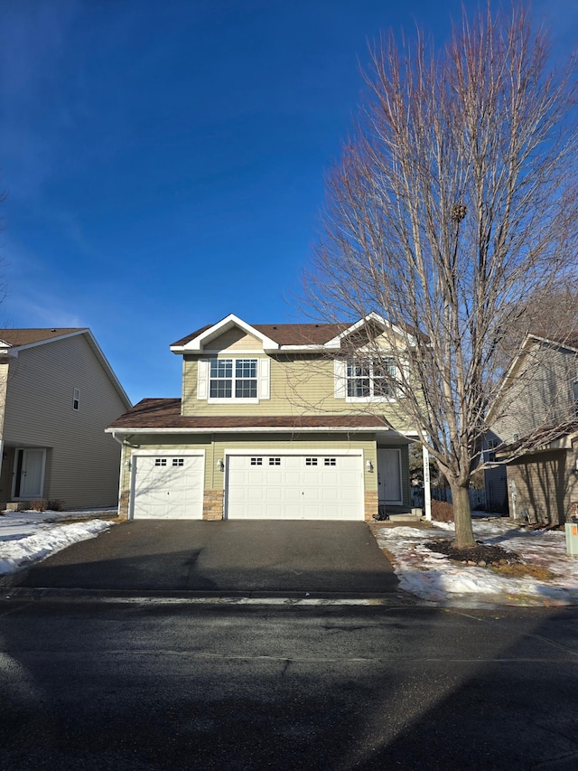 traditional home with driveway and an attached garage