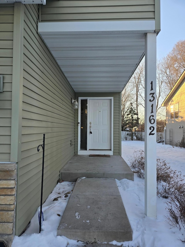 view of snow covered property entrance