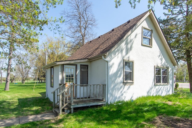 4647 County Road 121, Fort Ripley, MN 56449 - view of front of home with stucco siding, roof with shingles, and a front yard