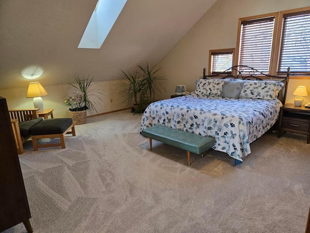 bedroom with carpet floors and lofted ceiling with skylight