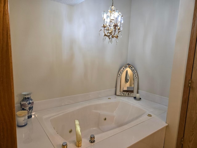 full bath featuring a chandelier and a jetted tub