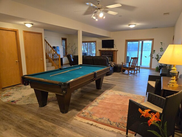 recreation room featuring a healthy amount of sunlight, billiards, and wood finished floors