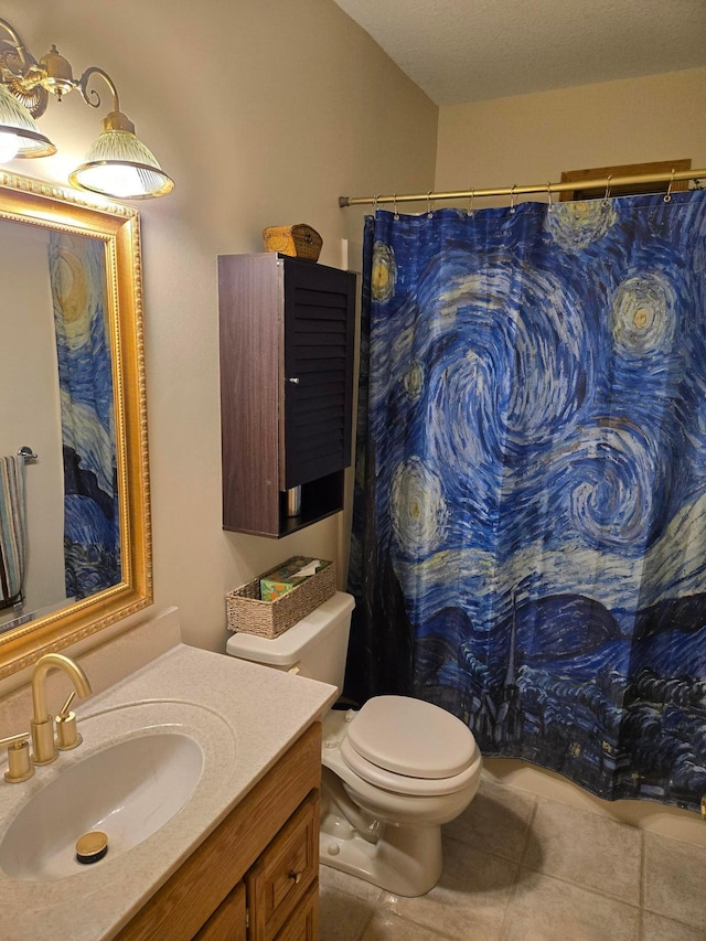 bathroom featuring toilet, vanity, tile patterned floors, and curtained shower