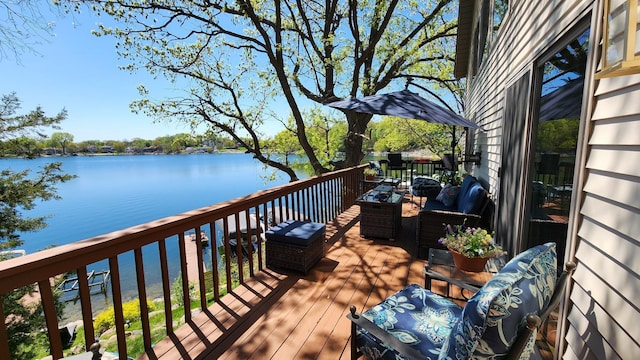 wooden deck featuring a water view