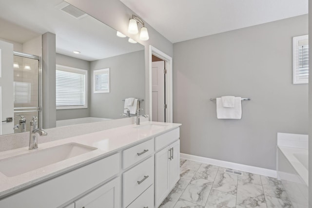 full bath featuring a shower stall, marble finish floor, a sink, and baseboards