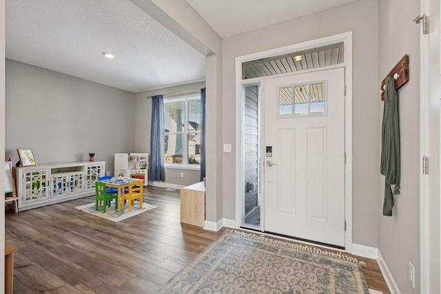 foyer entrance featuring wood finished floors and baseboards