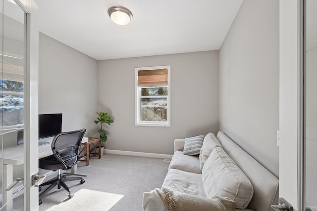 office space featuring baseboards and light colored carpet