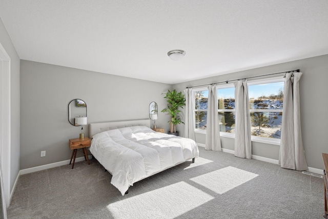 bedroom featuring carpet floors and baseboards